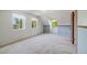 Spacious carpeted bedroom featuring multiple windows, providing ample natural light at 12218 Monroe Dr, Thornton, CO 80241