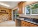 Well-equipped kitchen with stainless steel appliances, tile floors, and a view to the backyard at 12218 Monroe Dr, Thornton, CO 80241