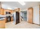 Kitchen features stainless steel appliances, light wood cabinets, tile floors, and lots of storage space at 12218 Monroe Dr, Thornton, CO 80241