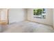 Bright living room features neutral carpeting and large windows, offering ample natural light at 12218 Monroe Dr, Thornton, CO 80241