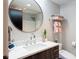 This modern bathroom has a sleek vanity, a round mirror, and a glass-enclosed shower at 1590 Little Raven St # 408, Denver, CO 80202
