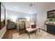 Cozy bedroom with hardwood floors, a jukebox, and a comfortable sitting area at 1590 Little Raven St # 408, Denver, CO 80202