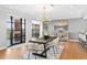 Dining area featuring modern light fixture, seating for six, and oversized windows leading to outdoor space at 1590 Little Raven St # 408, Denver, CO 80202
