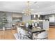 Open concept dining area with modern light fixture, seating for six, and adjacent to stylish kitchen at 1590 Little Raven St # 408, Denver, CO 80202