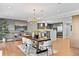 Open concept dining area with modern light fixture, seating for six, and adjacent to stylish kitchen at 1590 Little Raven St # 408, Denver, CO 80202