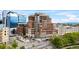 Exterior view of luxurious brick condo building with upscale retail and office space and beautiful landscaping at 1590 Little Raven St # 408, Denver, CO 80202