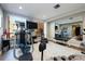 Home gym with an elliptical machine, weight bench, TV, and mirrored wall at 1590 Little Raven St # 408, Denver, CO 80202