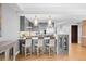 Open kitchen with pendant lighting, island seating, stainless steel appliances, and hardwood floors at 1590 Little Raven St # 408, Denver, CO 80202