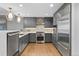Modern kitchen with stainless steel appliances, sleek cabinetry, granite countertops, and hardwood floors at 1590 Little Raven St # 408, Denver, CO 80202
