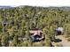 Mountain property featuring a secluded home surrounded by mature trees, with neighborhood homes scattered nearby at 2976 Hiwan Dr, Evergreen, CO 80439