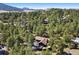 Secluded mountain property featuring a beautiful home surrounded by mature trees in a peaceful, natural setting at 2976 Hiwan Dr, Evergreen, CO 80439