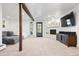 Finished basement area with a fireplace, TV, and walk-out access to the outdoors at 2976 Hiwan Dr, Evergreen, CO 80439