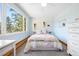 Bright bedroom featuring a large window with a view of the surrounding trees at 2976 Hiwan Dr, Evergreen, CO 80439