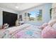 Bright bedroom featuring a large window with a view of the surrounding trees and a work desk at 2976 Hiwan Dr, Evergreen, CO 80439