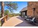 Spacious wooden deck with comfortable seating and picturesque views of the surrounding forest at 2976 Hiwan Dr, Evergreen, CO 80439