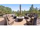 Outdoor patio with seating, pillows, and views of the pine trees at 2976 Hiwan Dr, Evergreen, CO 80439