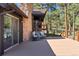 Deck area with a stone fireplace, outdoor seating, and gorgeous views at 2976 Hiwan Dr, Evergreen, CO 80439