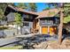 Charming exterior featuring a two-story home, a basketball hoop, and a two-car garage at 2976 Hiwan Dr, Evergreen, CO 80439