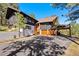 Inviting exterior showcasing a two-story home, a spacious driveway, and a two-car garage at 2976 Hiwan Dr, Evergreen, CO 80439