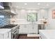 Stylish kitchen features stainless steel appliances, modern cabinetry, and decorative backsplash at 2976 Hiwan Dr, Evergreen, CO 80439