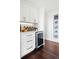 Kitchen area with white cabinets and wine refrigerator at 2976 Hiwan Dr, Evergreen, CO 80439
