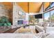 Inviting living room showcasing a stone fireplace, wood ceilings, and access to deck at 2976 Hiwan Dr, Evergreen, CO 80439
