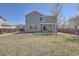 Exterior elevation of a two-story home with a walkout patio and a large grassy yard at 1169 N Tabor Dr, Castle Rock, CO 80104