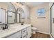 Modern bathroom featuring dual sinks, quartz counters, and dark hardware at 1169 N Tabor Dr, Castle Rock, CO 80104