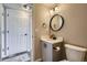 Cozy bathroom featuring stylish vanity, modern fixtures, and a round mirror at 1169 N Tabor Dr, Castle Rock, CO 80104
