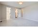 This bedroom features neutral carpet, and multiple doors to additional rooms and closets at 1169 N Tabor Dr, Castle Rock, CO 80104