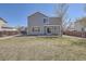 Exterior elevation of a two-story home with a walkout patio and a large grassy yard at 1169 N Tabor Dr, Castle Rock, CO 80104