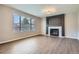 Inviting living room with modern fireplace, a large window, and wood-look flooring at 1169 N Tabor Dr, Castle Rock, CO 80104
