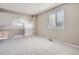 Cozy carpeted loft space featuring railing that overlooks the floor below and a sunny window at 1169 N Tabor Dr, Castle Rock, CO 80104