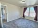 Bedroom with window, carpet, and access to another room at 7982 Larkspur Cir, Frederick, CO 80530