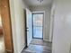 Bright entryway with wood-look floors and door leading to backyard at 7982 Larkspur Cir, Frederick, CO 80530