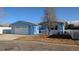 Cute blue house with white fence and a two-car garage at 7982 Larkspur Cir, Frederick, CO 80530