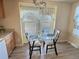 Kitchen with glass-top table and view to backyard at 7982 Larkspur Cir, Frederick, CO 80530