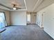 Large main bedroom with plush carpet and access to other rooms at 7982 Larkspur Cir, Frederick, CO 80530