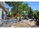 Outdoor patio with brick walkway, mature trees, and backyard at 9222 Albion St, Thornton, CO 80229