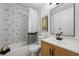 Well-lit bathroom with modern geometric tile, updated vanity, and contemporary fixtures at 9222 Albion St, Thornton, CO 80229