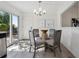 Bright dining area featuring a stylish table setting, natural light, and easy access to the backyard at 9222 Albion St, Thornton, CO 80229