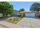 Charming home with a blend of brick and siding, complemented by a well-maintained yard and mature trees at 9222 Albion St, Thornton, CO 80229