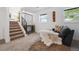 Cozy living room features modern decor, a comfortable sofa, and staircase to the upper level at 9222 Albion St, Thornton, CO 80229