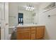 Bathroom with a large mirror, double sinks, and wooden cabinets providing ample storage space at 4385 S Balsam St # 3-101, Littleton, CO 80123