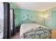 Tranquil bedroom featuring a decorative bed frame, teal walls, and curtains by a window at 4385 S Balsam St # 3-101, Littleton, CO 80123