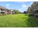Well-maintained common green space among condo buildings, enhanced by mature trees and lush landscaping at 4385 S Balsam St # 3-101, Littleton, CO 80123