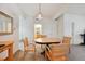 Bright dining room featuring a wooden table with chairs, a decorative light fixture, and convenient access to other rooms at 4385 S Balsam St # 3-101, Littleton, CO 80123