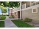 The exterior of the property features well-maintained landscaping and neutral tones, with a sidewalk leading to the entrance at 4385 S Balsam St # 3-101, Littleton, CO 80123