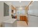 Well-lit kitchen showcasing wooden cabinets, a window over the sink, and standard appliances at 4385 S Balsam St # 3-101, Littleton, CO 80123