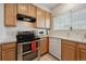 Functional kitchen featuring wooden cabinets, modern appliances, and ample counter space for meal preparation at 4385 S Balsam St # 3-101, Littleton, CO 80123